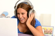 activity,adolescence,bed,bedroom,caucasian,cheerful,computer,enjoying,entertainment,fun,funny,girl,happy,headphones,indoor,internet,laptop,laughing,leisure,lifestyle,listening,lying,movie,music,relaxing,studying,surfing,teenager,using,watching,woman,young