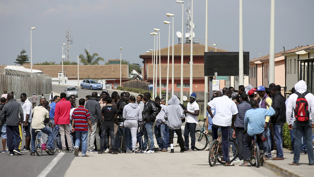 Migrants gather at an immigration center in Mineo, on the Italian island of Sicily
