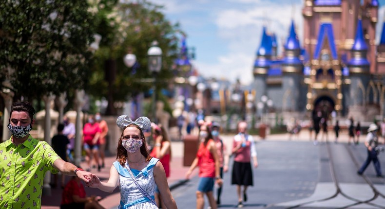 Guests wear required face masks due to the Covid-19 pandemic on Main Street, U.S.A. in front of Cinderella Castle at Walt Disney World Resort's Magic Kingdom on Wednesday, August 12, 2020, in Lake Buena Vista, Fla.