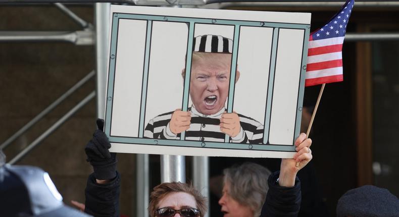 Demonstrators gather outside of Manhattan Criminal Court as a grand jury is expected to vote this week on whether to indict former US President Donald Trump on March 21, 2023 in New York City.Scott Olson/Getty Images