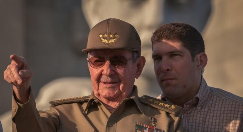 Cuban President Raul Castro, next to his grandson and bodyguard, attends the May Day parade in Havana on May 1, 2017