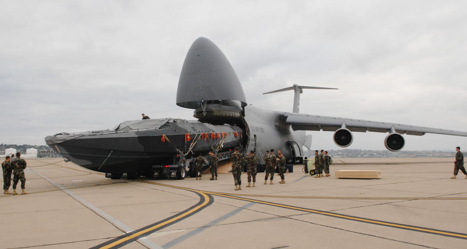 Here the C-5 unloads an 81-foot boat for the Navy.