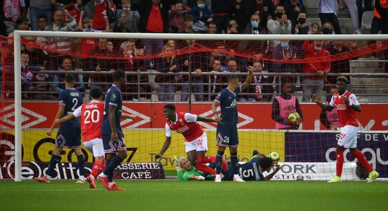 Zimbabwean Marshall Munetsi (C) celebrates after putting the ball in the net for Reims against Paris Saint-Germain, but the goal was disallowed for offside Creator: FRANCK FIFE