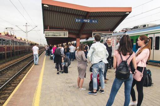 Many people with Luggage on the platform waiting for the delayed train