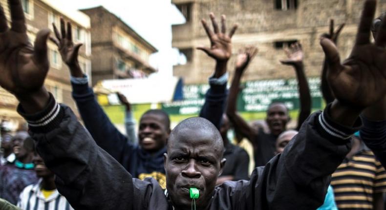 Opposition supporters march through Nairobi's Mathare slum, shouting 'Uhuru must go'