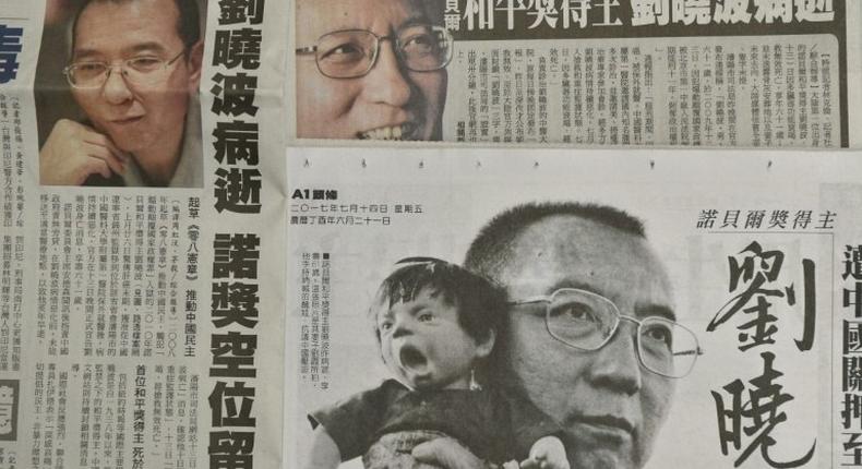 This photo illustration shows a collection of Taiwanese newspapers in Taipei on July 14, 2017 reporting on the death of China's Nobel laureate Liu Xiaobo