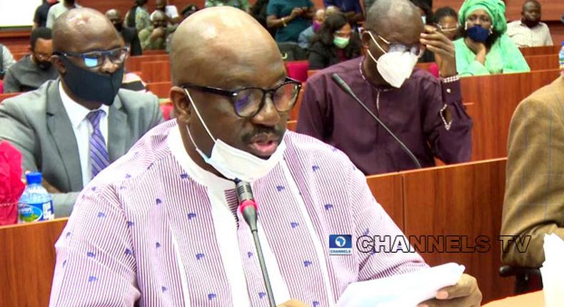 In this photo taken on July 14, 2020, acting Managing Director of the NDDC, Professor Kemebradikumo Pondei, reads from a paper during the agency’s 2019 budget defence at the National Assembly in Abuja. [channelstv]