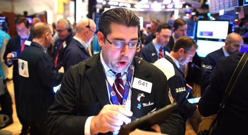 Traders work during the opening bell at the New York Stock Exchange (NYSE)