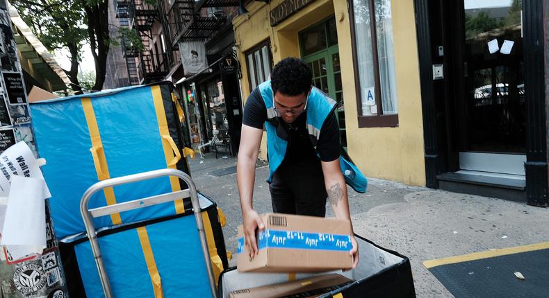 An Amazon worker moves boxes on Amazon Prime DaySpencer Platt/Getty Images