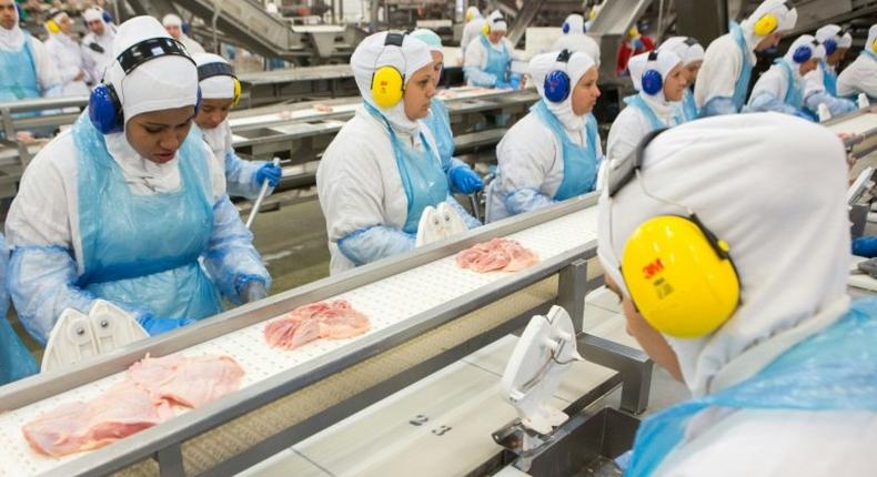 People work at a production line of the JBS-Friboi chicken processing plant during an inspection visit from Brazilian Agriculture Minister Blairo Maggi and technicians of the ministry in Lapa, Parana State, Brazil on March 21, 2017