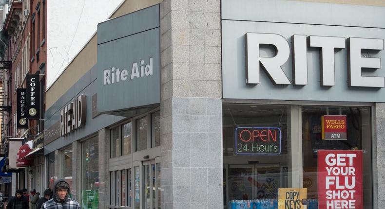 People walk past a Rite Aid store in Chelsea, New York   in 2018.