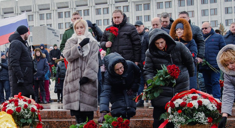 Participants lay flowers near the Eternal Flame memorial as they gather in Glory Square the day after Russia's Defence Ministry stated that 63 Russian servicemen were killed in a Ukrainian missile strike on their temporary accommodation in Makiivka.REUTERS/Albert Dzen