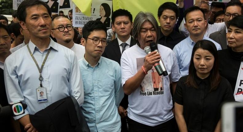 Hong Kong pro-democracy lawmakers Edward Yiu Chung-yim (L), Nathan Law (2nd L), Leung Kwok-hung also known as 'long hair' (C) and Lau Siu-lai (R) have been disqualified from parliament after changing their oaths of office