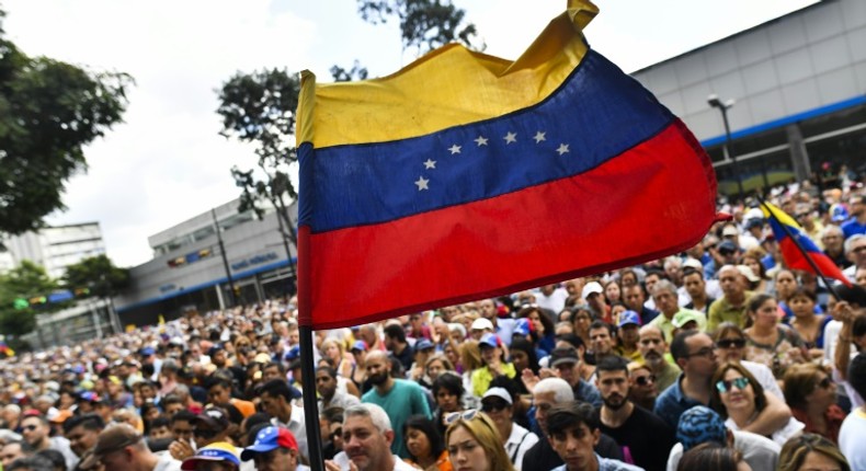 Anti-government activists listen to the president of Venezuela's opposition-led National Assembly Juan Guaido in Caracas on January 11, 2019