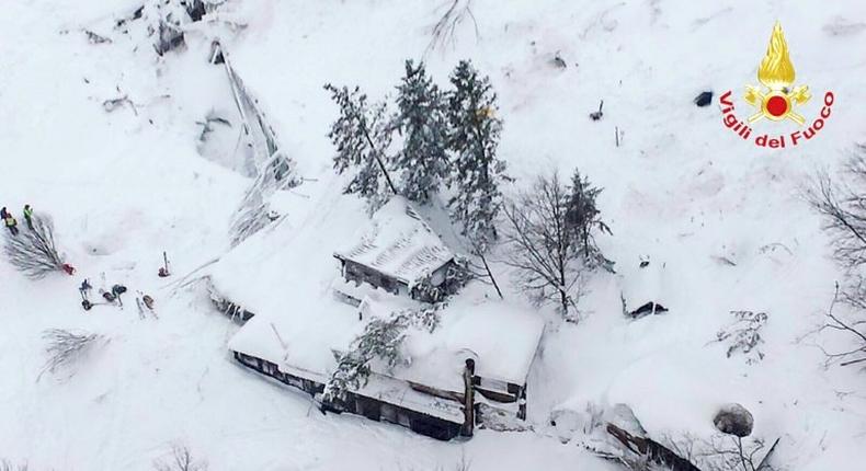 This handout image obtained on the Vigili del Fuoco twitter account on January 19, 2017 shows an aerial view of the Hotel Rigopiano, near the village of Farindola, on the eastern lower slopes of the Gran Sasso mountain, engulfed by a powerful avalanche.Up to 30 people were feared to have died after an Italian mountain Hotel Rigopiano was engulfed by a powerful avalanche in the earthquake-ravaged centre of the country. Italy's Civil Protection agency confirmed the Hotel Rigopiano had been engulfed by a two-metre (six-feet) high wall of snow and that emergency services were struggling to get ambulances and diggers to the site.