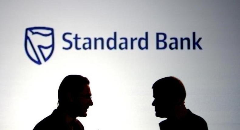 Businessmen chat in front of a Standard Bank logo in Sandton outside Johannesburg  in a file photo.

    REUTERS/Siphiwe Sibeko