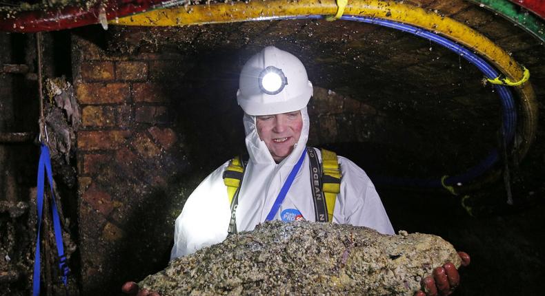 Worker holding fatberg UK