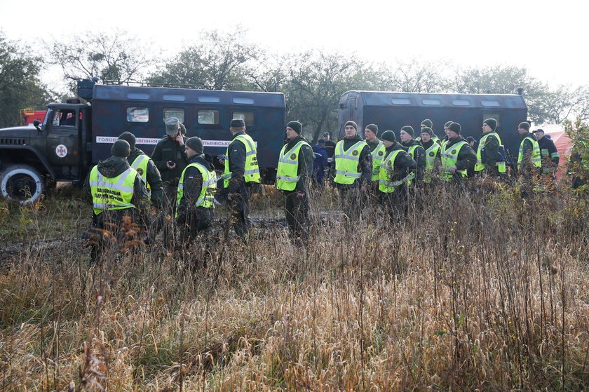 Medics assist a wounded person at the site of the Antonov-12 cargo airplane emergency landing in Lvi