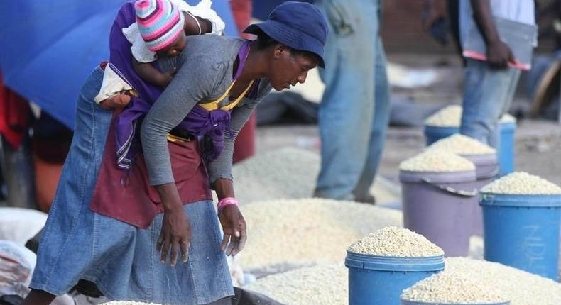 A Zimbabwean woman sells maize in the capital Harare, March 3, 2- RTSAGJ3
