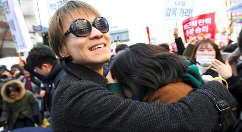 Anti-government activists celebrate the dismissal of South Korean President Park Geun-Hye, March 10, 2017