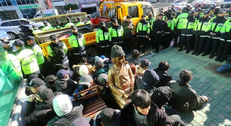 The statue of a 'comfort woman' (C) in Busan, South Korea, that has provoked the recall of Japan's ambassador to its neighbour