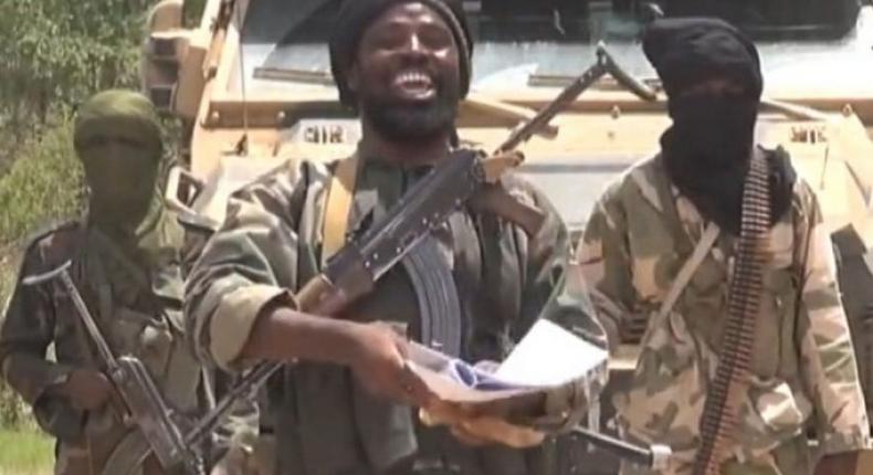 Boko Haram leader, who is rumoured to have been killed, is flanked by his fellow terrorists.