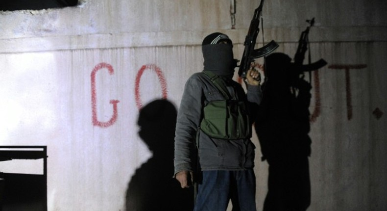 A Free Syrian Army rebel stands guard in the north Syrian city of Binnish