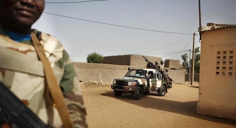 Soldiers from the Waraba Battalion, an EU-trained Malian army battalion, ride in military vehicles in Gao July 8, 2013. Picture taken July 8, 2013. REUTERS/Malin Palm
