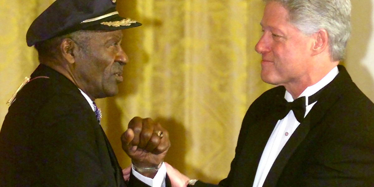 U.S. President Bill Clinton shakes hands with Kennedy Center Award honoree Chuck Berry during a ceremony in the East Room of the White House in Washington December 3, 2000.