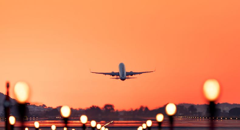 Airplane taking off at sunrise.Daniel Garrido/Getty Images
