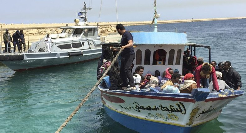 Illegal migrants who attempted to sail to Europe sit in a boat returning them to Libya as it is docked, after their boat was intercepted at sea by the Libyan coast guard, at Khoms, Libya May 6, 2015. REUTERS/Aymen Elsahli