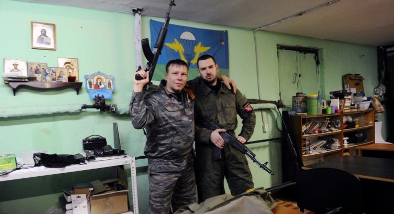 Members of the Russian Imperial Movement who are volunteers of the self-declared Donetsk People's Republic pose with weapon simulators at a training base in Saint Petersburg in 2015