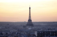 The Eiffel Tower is seen at sunset in Paris