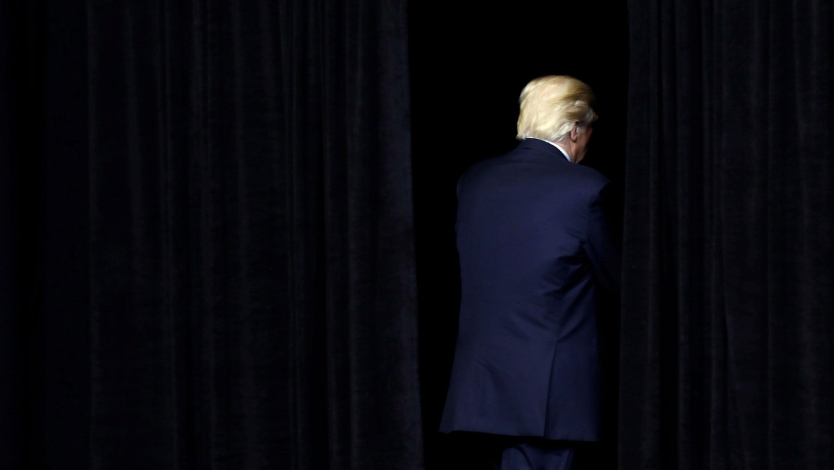 U.S. President Donald Trump exits the stage following a rally at the U.S. Cellular Center in Cedar R