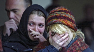 Women mourn during commemoration ceremony at the Dubrovka Theatre in Moscow