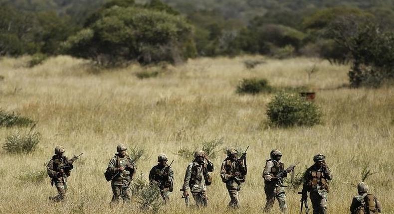 Members of the South African National Defence Force (SANDF) return after taking part in a Capability Demonstration at the Roodewal Bombing Range in Makhado, in the northern province of Limpopo, May 9, 2013. REUTERS/Siphiwe Sibeko