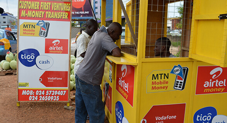 Mobile money agent and his customers