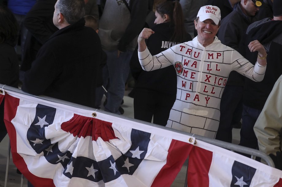 A man in costume poses for a photo after a Donald Trump campaign event at an airplane hanger in Rochester, New York, April 10, 2016.