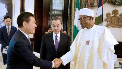 Nigeria’s President Muhammadu Buhari greets China’s Foreign Minister Wang Yi (C) and Chinese Ambassador to Nigeria Zhou Pingjian during their visit to the Presidential Villa in Abuja, Nigeria [REUTERS]