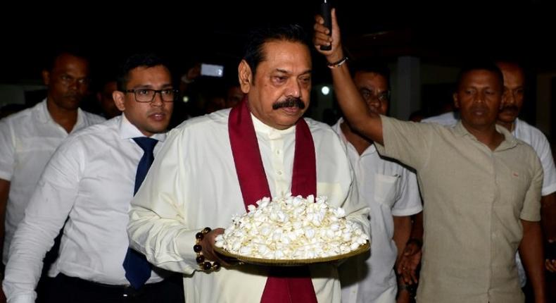 The crisis was sparked by the president sacking the prime minister and naming former strongman leader Mahinda Rajapakse (C) in his place