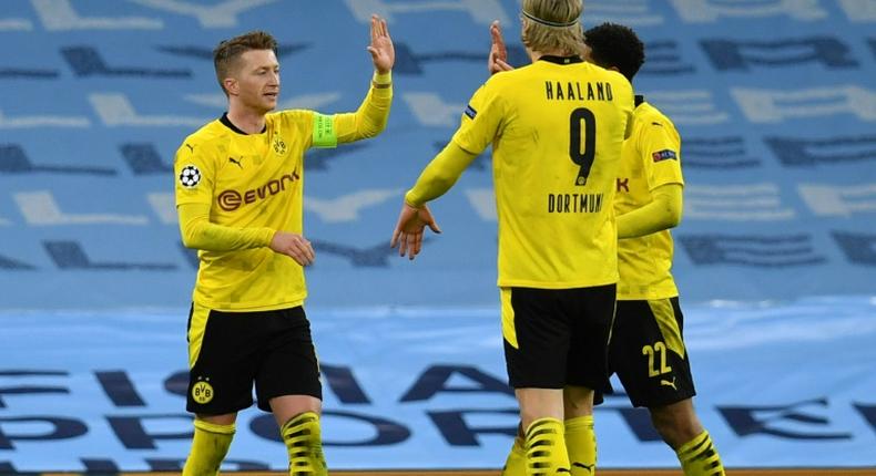 Borussia Dortmund captain Marco Reus (L) celebrates his goal at Manchester City in Tuesday's 2-1 away defeat