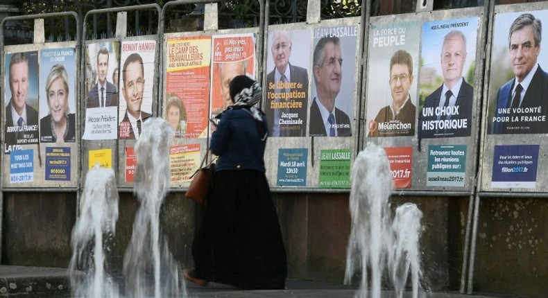 Campaign posters for the French presidential candidates cover a wall in Strasbourg, eastern France