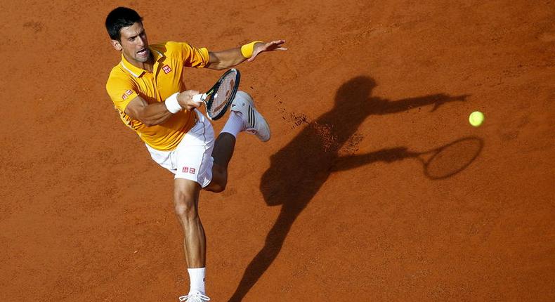 Novak Djokovic of Serbia returns the ball to Nicolas Almagro of Spain during their match at the Rome Open tennis tournament in Rome, Italy, May 12, 2015. REUTERS/Tony Gentile
