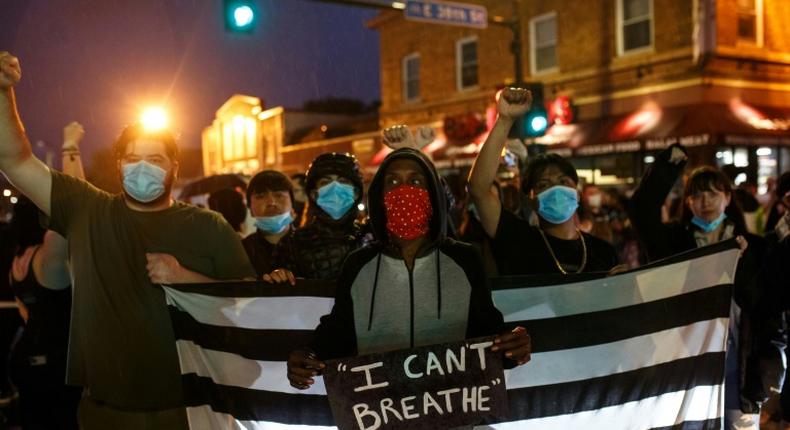 Protesters gather near the scene where George Floyd died in police custody in Minneapolis