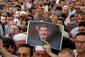 A man holds a picture of the former Egyptian president Mursi during a symbolic funeral prayer in Istanbul