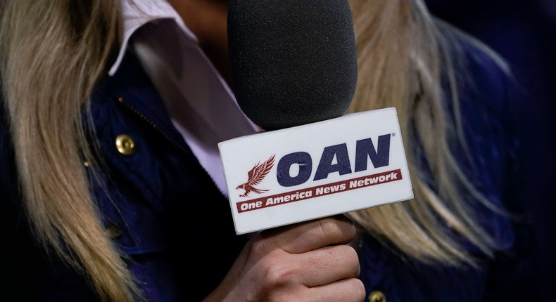 A reporter with One America News Network works at a campaign rally with President Donald Trump on September 25, 2020 in Newport News, Virginia.
