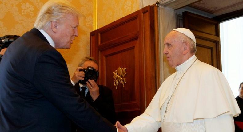 Pope Francis shakes hands with US President Donald Trump during a private audience at the Vatican