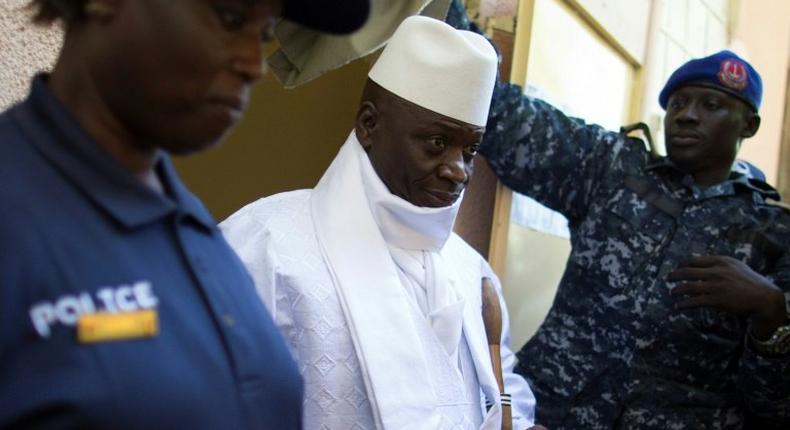 Gambia's President Yahya Jammeh (centre) leaves a polling booth in Banjul on December 1, 2016