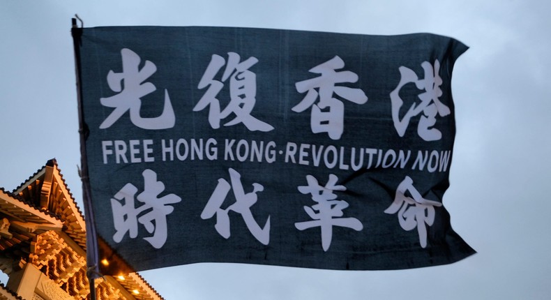 LIBERTY SQUARE, TAIPEI, TAIWAN - 2020/06/13: A flag with written on it: Free Hong Kong Revolution waved in front of Taipei Chiang Kai Sheck memorial.A group of mostly young Taiwanese and Taiwan expatriates Hongkongers demonstrate against China rule on the territory in Liberty Square downtown Taipei. The demonstration, one of the many held in Taiwan, was set to commemorate the anniversary, one year, since the protest started in Hong Kong against several laws that were to be implemented in Hong Kong. (Photo by Alberto Buzzola/LightRocket via Getty Images)