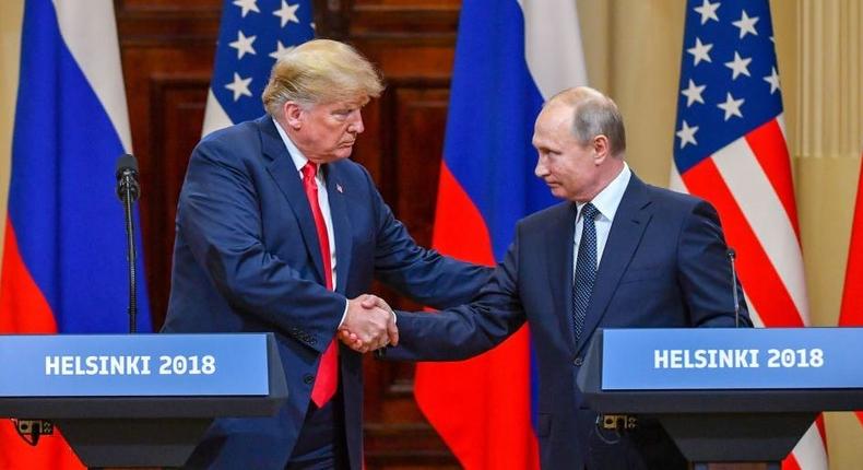 US President Donald Trump and Russia's President Vladimir Putin shake hands  after a meeting in Helsinki, Finland, in July 2018.YURI KADOBNOV/AFP via Getty Images